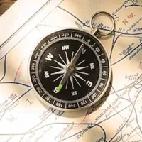 Map compass with wooden background